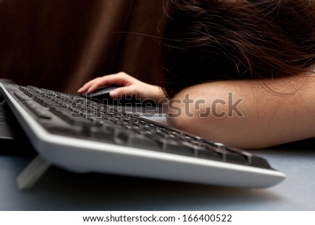 Picture of a cute teenage girl sleeping on her computer