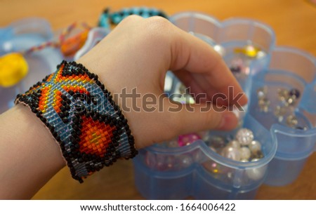needlework. woven bracelets from ribbons, woven bracelets from beads. needlework accessories,hobby needlework