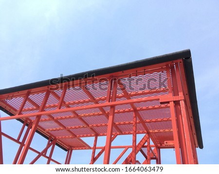 The red steel stair structure at the company.