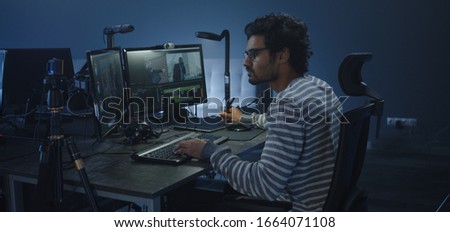 Medium shot of a film editor working on a movie