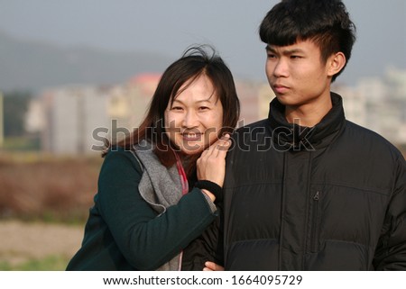 The mother leaned happily by her son's side Royalty-Free Stock Photo #1664095729