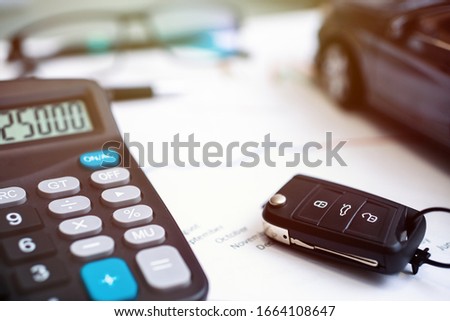 car sales chart concept visual. car keys, graphics and calculator