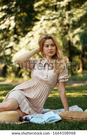 Young girl in pink dress at a picnic in the summer