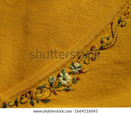 Embroidered flowers on the fabric. Ukrainian folk hand embroidery.