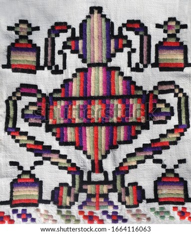 The embroidered ornament on the fabric. Ukrainian folk hand embroidery.  On white background.