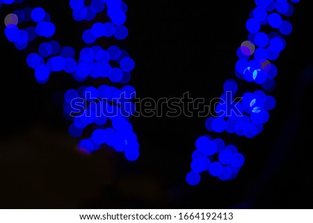 Large blue blurry lights on an isolated black background. Texture for banner, postcards. Fabulousness