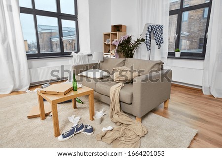 mess, disorder and interior concept - view of messy home living room with scattered stuff Royalty-Free Stock Photo #1664201053