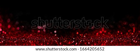 Abstract blur red glitter on black background. Card for Valentine's day, christmas and wedding celebration. Love bokeh sparkle confetti textured layout. Classy elegant design.