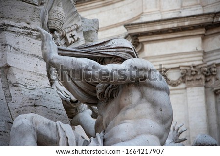 Fountain of the Four Rivers by Gian Lorenzo Bernini, baroque creation located in the center of Piazza Navona, Rome, Italy. Giant white marble statue represents the Nile river allegory. Royalty-Free Stock Photo #1664217907