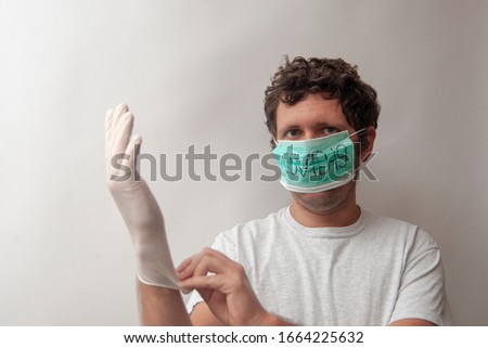 Coronavirus (COVID-19) outbreak. Young man in medical mask with medical white glove on white background isolated on white. Concept of virus COVID-19 or 2019-nCoV, coronavirus, illness.
