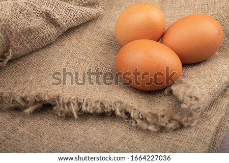 Chicken eggs on a background of rough homespun fabric. Country food.Close up.
