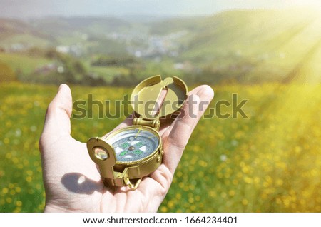 Traveler holding compass in the hand 
