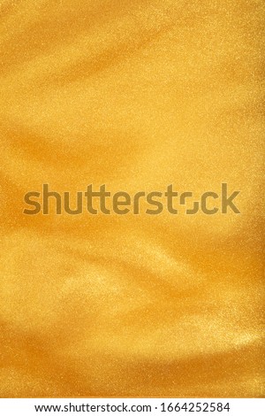 Liquid shiny gold in a soft texture