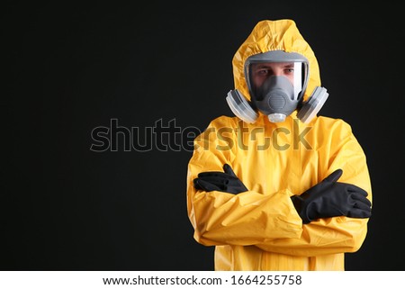 Man wearing chemical protective suit on black background, space for text. Virus research Royalty-Free Stock Photo #1664255758