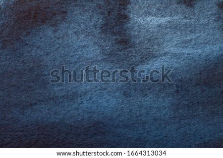 Abstract art background navy blue and black colors. Watercolor painting on canvas with denim gradient. Fragment of artwork on paper with pattern. Texture backdrop, macro.