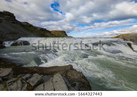 Front View Picture of Dettifoss Icelandic Waterfall with White Clouds on the Sky