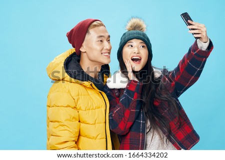 Cheerful beautiful young couple studio fashion winter lifestyle