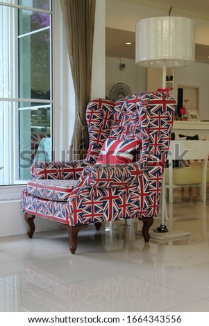 The British flag armchair on a white tile floor.