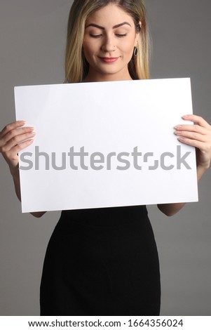Fun business woman holding white empty paper. Advertisement mockup template for agencies.