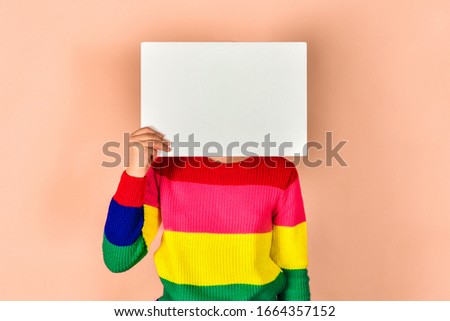 Girl holding a blank poster for inscription and text.