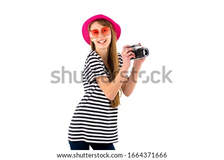 Portrait of smiling girl in striped summer casual clothes,red hat with photo camera isolated on white background. Female passenger traveling abroad to travel on weekends getaway.Journey concept.