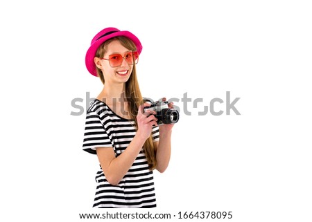 stylish teenage girl photographer in glasses holds an old camera on a white isolated background Banner advertisement
 