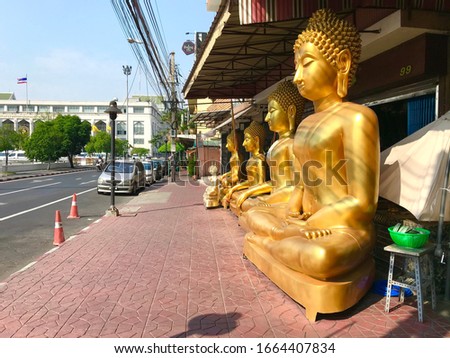 Group of Buddha images and statues in front of manufacturer showroom ready to deliver to temples all around the country in Phra Nakhon District, Bangkok, Thailand.
