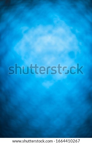 blue saturated abstract image, defocused photo through glass. for background. vignetted