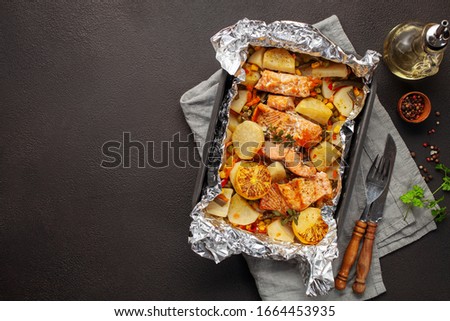 Foil pack dinners. Salmon with vegetables baked in foil. Dietary food. Top view Royalty-Free Stock Photo #1664453935