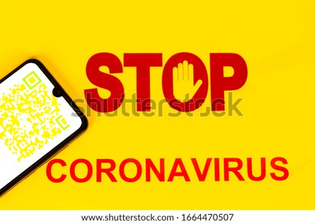 STOP Sign with yellow colorful QR Code on smart phone screen for coronavirus Covid-19 infection used in company for workers to know about their health virus infection. Yellow background.