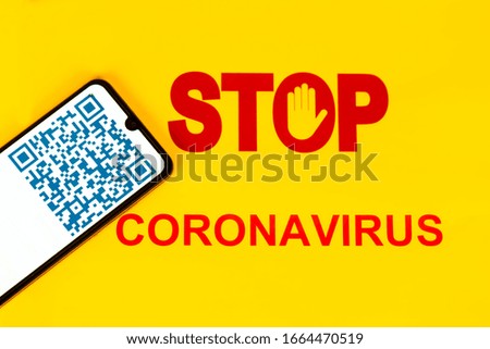 STOP Sign with blue colorful QR Code on smart phone screen for coronavirus Covid-19 infection used in company for workers to know about their health virus infection. Yellow background.