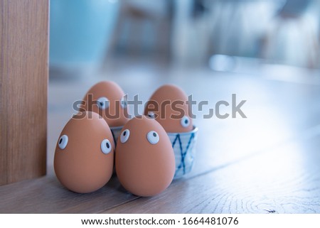 A group of Easter eggs with funny eyes is hidden early in the morning, children have to look for them. Happy Easter concept, Easter theme, background, postcard, screen, egg hunt, space for text, 