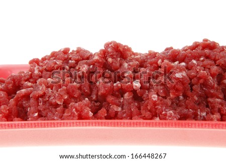 fresh raw mince beef meat on red tray isolated over white background