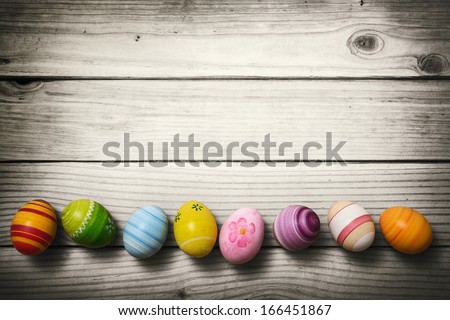 Easter eggs on wooden background Royalty-Free Stock Photo #166451867
