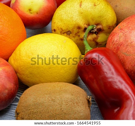 fresh fruits and vegetables on wooden background