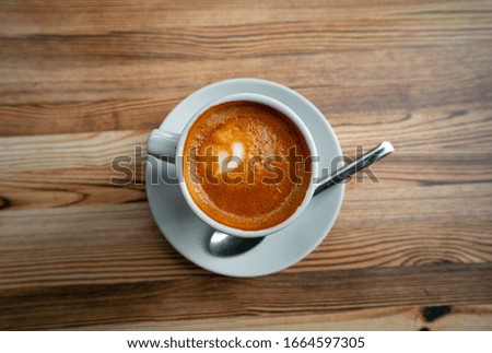 white coffee cup on wooden table