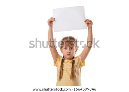 Happy cute child holding empty blank isolated on white background. kid with placard board for your text. girl with white sheet of paper. copy space