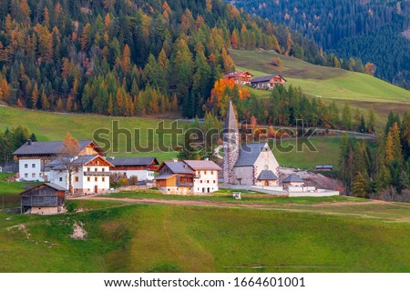 Famous village of Santa Maddalena at autumn colors in the background of the Odle mountain range, Funes valley Trentino Alto Adige region, South tyrol at sunset in Italy,Europe