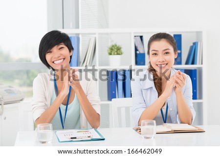 Portrait of businesswomen sitting at the seminar and posing at camera Royalty-Free Stock Photo #166462049
