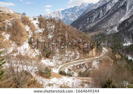 Mountain winding road in a snowy gorge