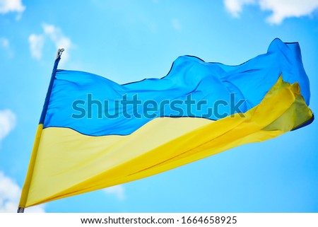 Ukraine flag on blue sky background 
