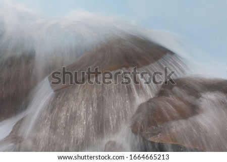 A time lapse image of a Patagonian stream flowing over the rocks in Los Glaciares National Park, Argentina