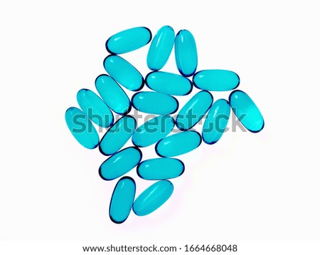 Blue oblong gel pill capsules. Arranged in a pattern.