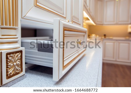 Furniture of the classic italian kitchen. Modern style. Design background. Home decoration. Modern home interior. Modern kitchen design in a light interior. Wood cupboard. Italian kitchen furniture .