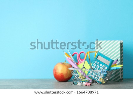 Apple and stationary on grey table. Study concept