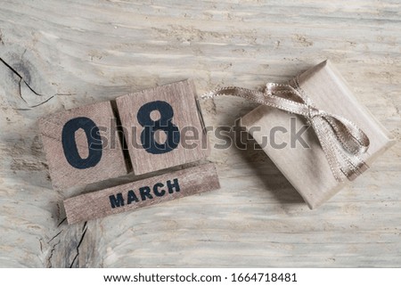 women day greeting template with cube calendar for march 08, on wooden background