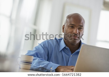 A group of people in the city. A business environment, an office workplace. A man sitting using a laptop. Royalty-Free Stock Photo #1664721382