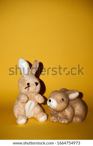 Plush Easter Bunny sitting against a yellow background.