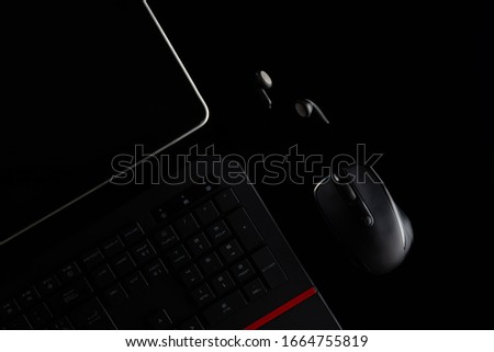 Top view of smartphone with flatlay composition of school supplies on desk of teenage child, computer, rulers and copybooks, mobile application education on a black background