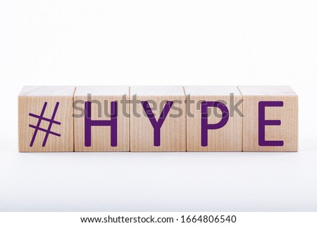 HYPE concept. Hype text on wooden cubes on a white background. Active aggressive obsessive advertising.